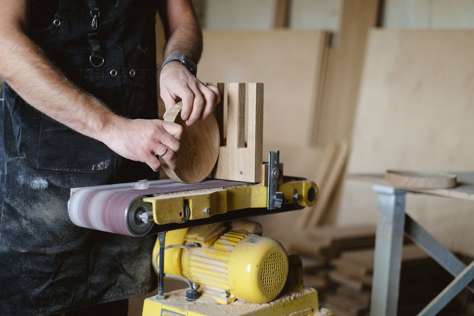 Carpenter meticulously sanding a custom wood piece